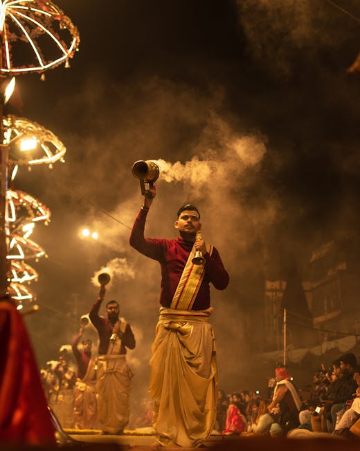 Vibrant scene of Ganga Aarti ceremony in Varanasi with priests in traditional attire.